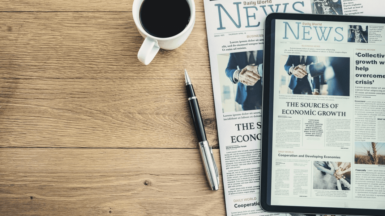 Newspaper, pen and coffee mug