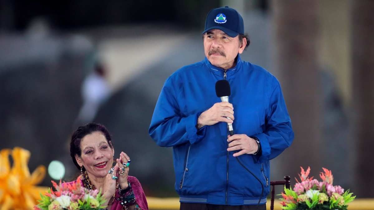 Nicaraguan President Daniel Ortega speaks to supporters with his wife