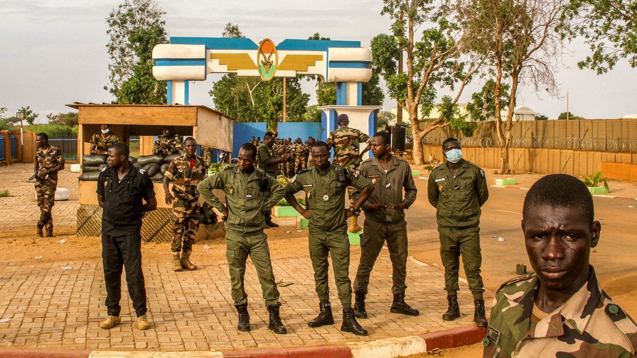 Niger's security forces stands guard as pro junta supporters take part in a demonstration in front of a French army base in Niamey, Niger.