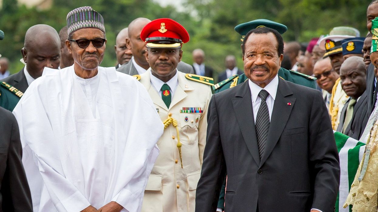 Nigeria's President Muhammadu Buhari(L) walks with Cameroon's President Paul Biya(R) as he arrives on an official visit to Cameroon in Yaounde July 29, 2015.The leaders of Nigeria and Cameroon pledged on Thursday to improve the exchange of intelligence and security cooperation along their border in a bid to tackle Nigerian Islamist militant group Boko Haram.Picture taken July 29, 2015.