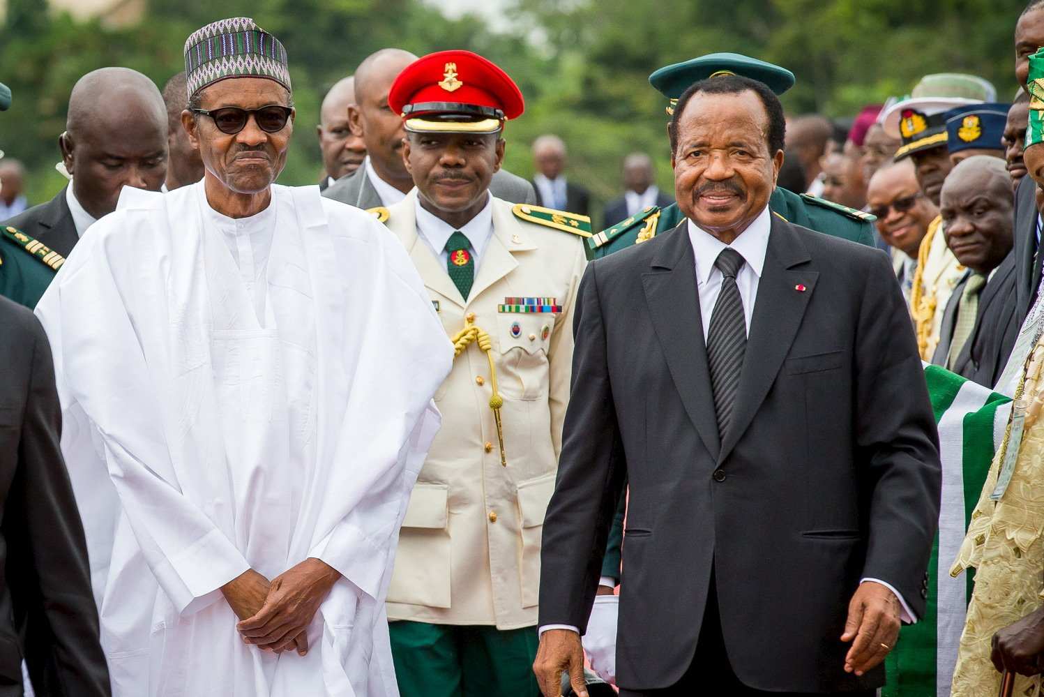 Nigeria's President Muhammadu Buhari(L) walks with Cameroon's President Paul Biya(R) as he arrives on an official visit to Cameroon in Yaounde July 29, 2015.The leaders of Nigeria and Cameroon pledged on Thursday to improve the exchange of intelligence and security cooperation along their border in a bid to tackle Nigerian Islamist militant group Boko Haram.Picture taken July 29, 2015.