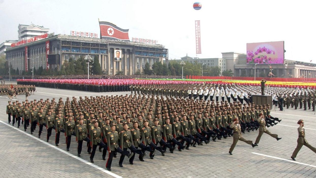 North Koreans take part in a parade to commemorate the 65th anniversary of the founding of the Workers' Party of Korea in Pyongyang October 10, 2010.