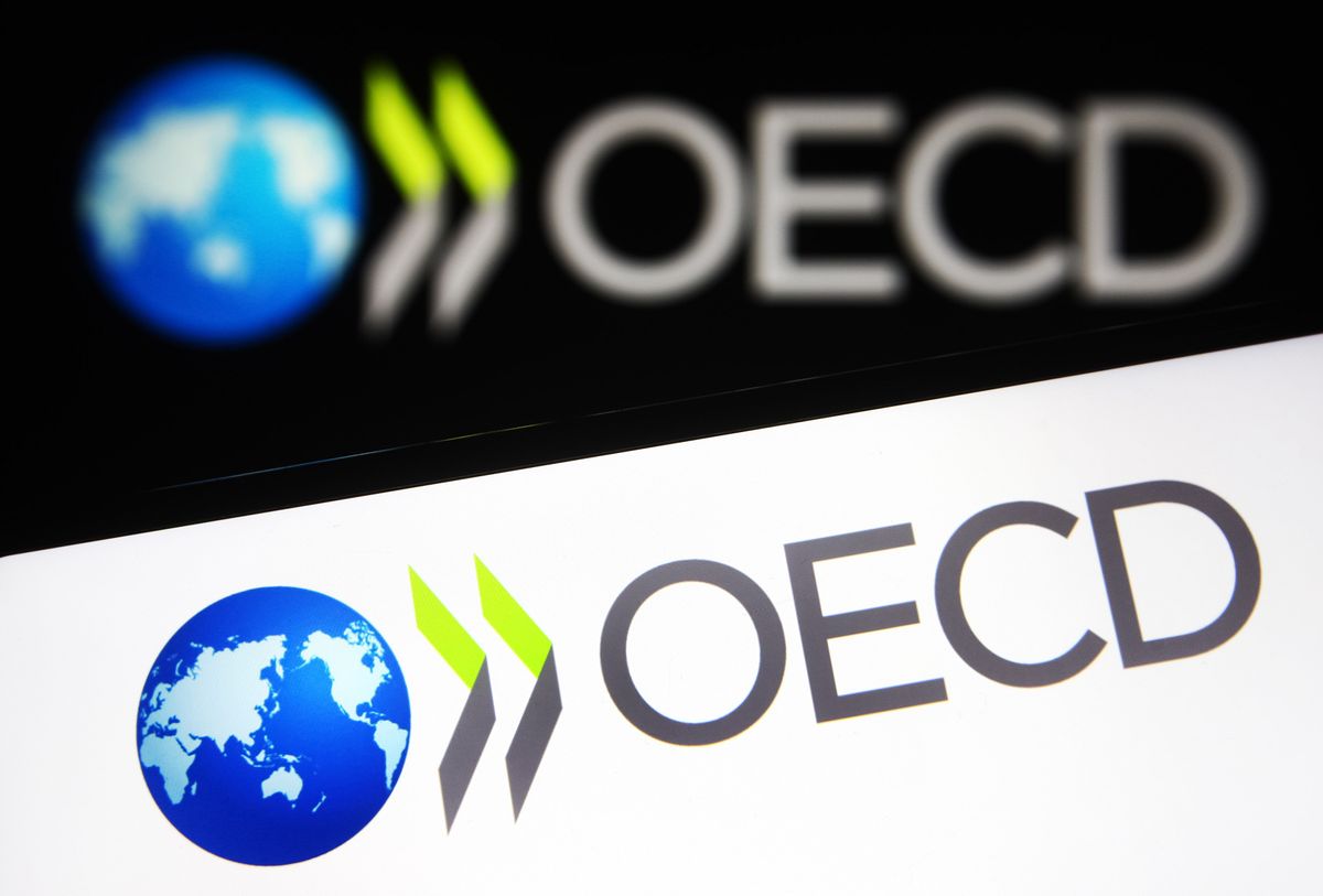 OECD logo seen on a smartphone and a computer screen. 