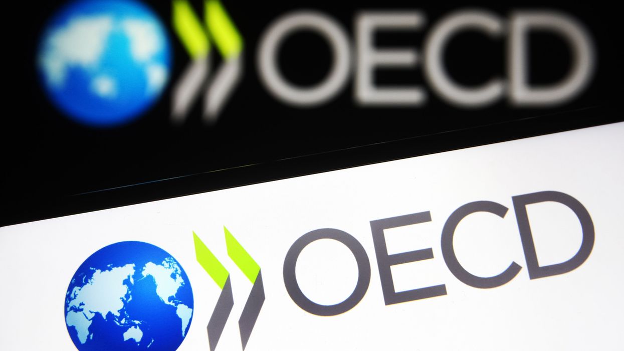 OECD logo seen on a smartphone and a computer screen.