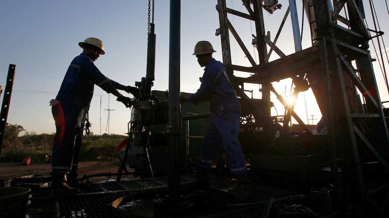 Oil workers drilling a well in an oil field, Venezuela.