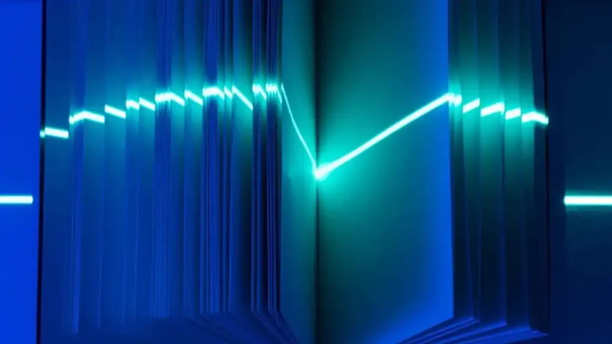 Open book with a laser pointing on the pages