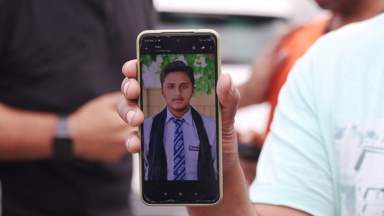 Pakistani Hassan Ali shows a photo of his brother who died in a shipwreck off the Greek coast.