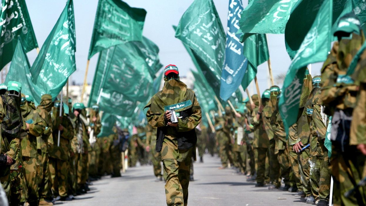 Palestinian militants from Hamas march during a Hamas rally in Nosirat refugee camp in Gaza Strip April 1, 2005. Islamic militant group Hamas is discussing whether it might join a Palestinian government after contesting parliamentary elections for the first time this July, the faction said on Thursday.