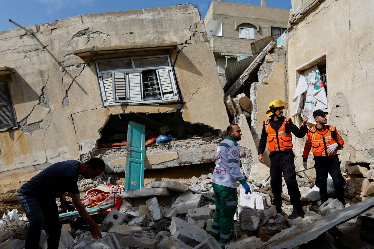 Palestinian rescue workers inspect a house after an Israeli strike in the southern Gaza Strip.