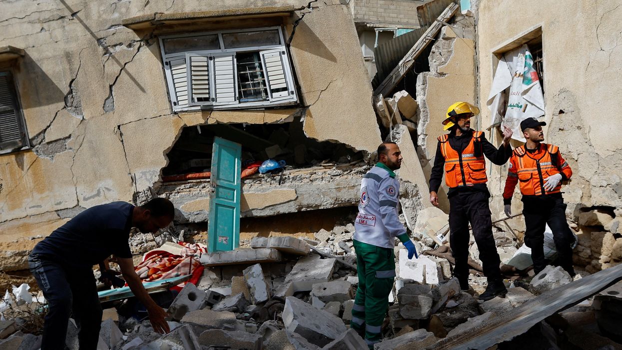Palestinian rescue workers inspect a house after an Israeli strike in the southern Gaza Strip.