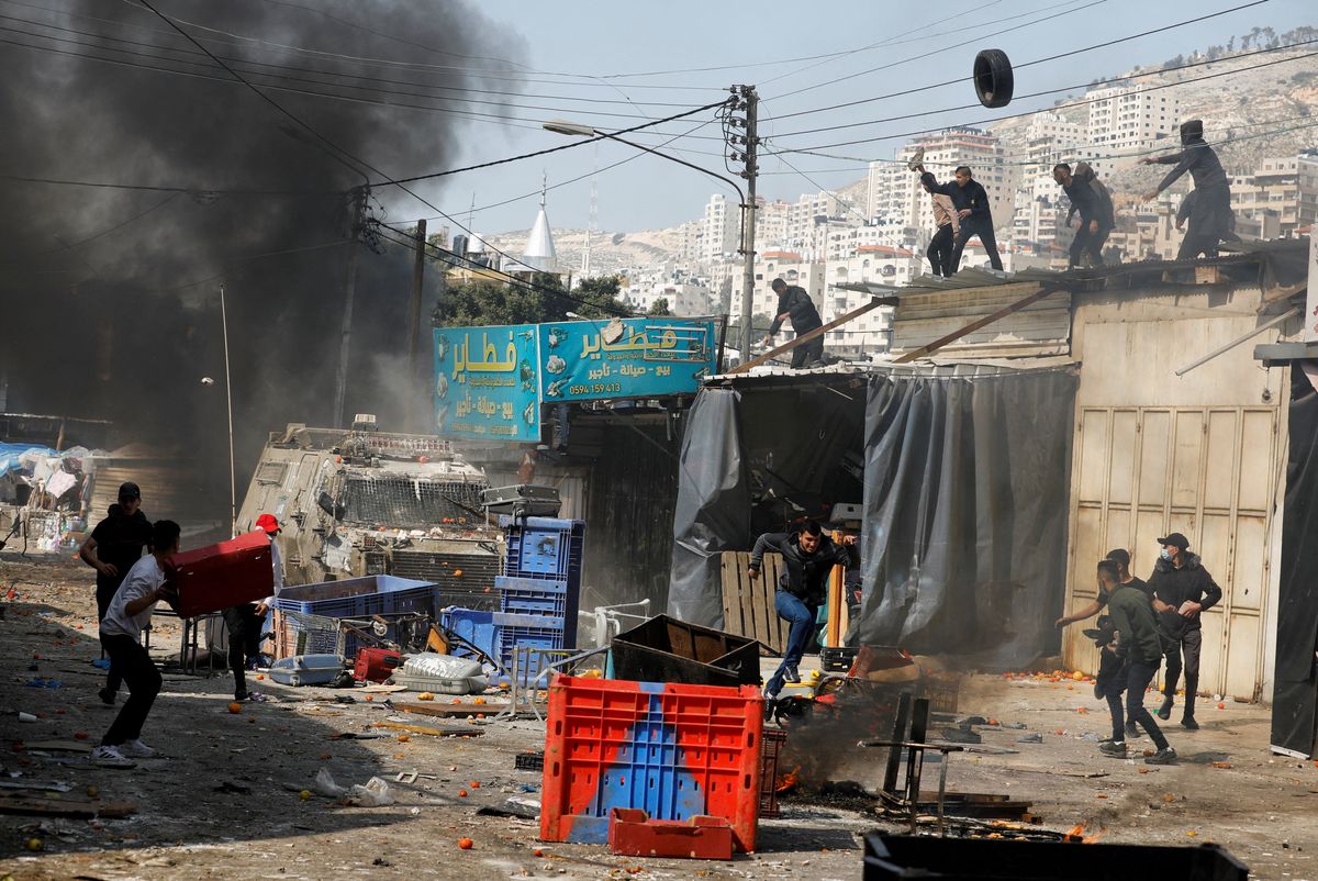 Palestinians clash with Israeli forces during a raid in Nablus in the Israeli-occupied West Bank, February 22, 2023.