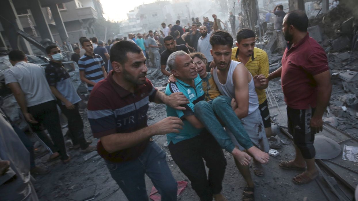 Palestinians evacuate an injured girl following an Israeli airstrike in central Gaza, on Oct. 18, 2023, amid the ongoing battles between Israel and Hamas.