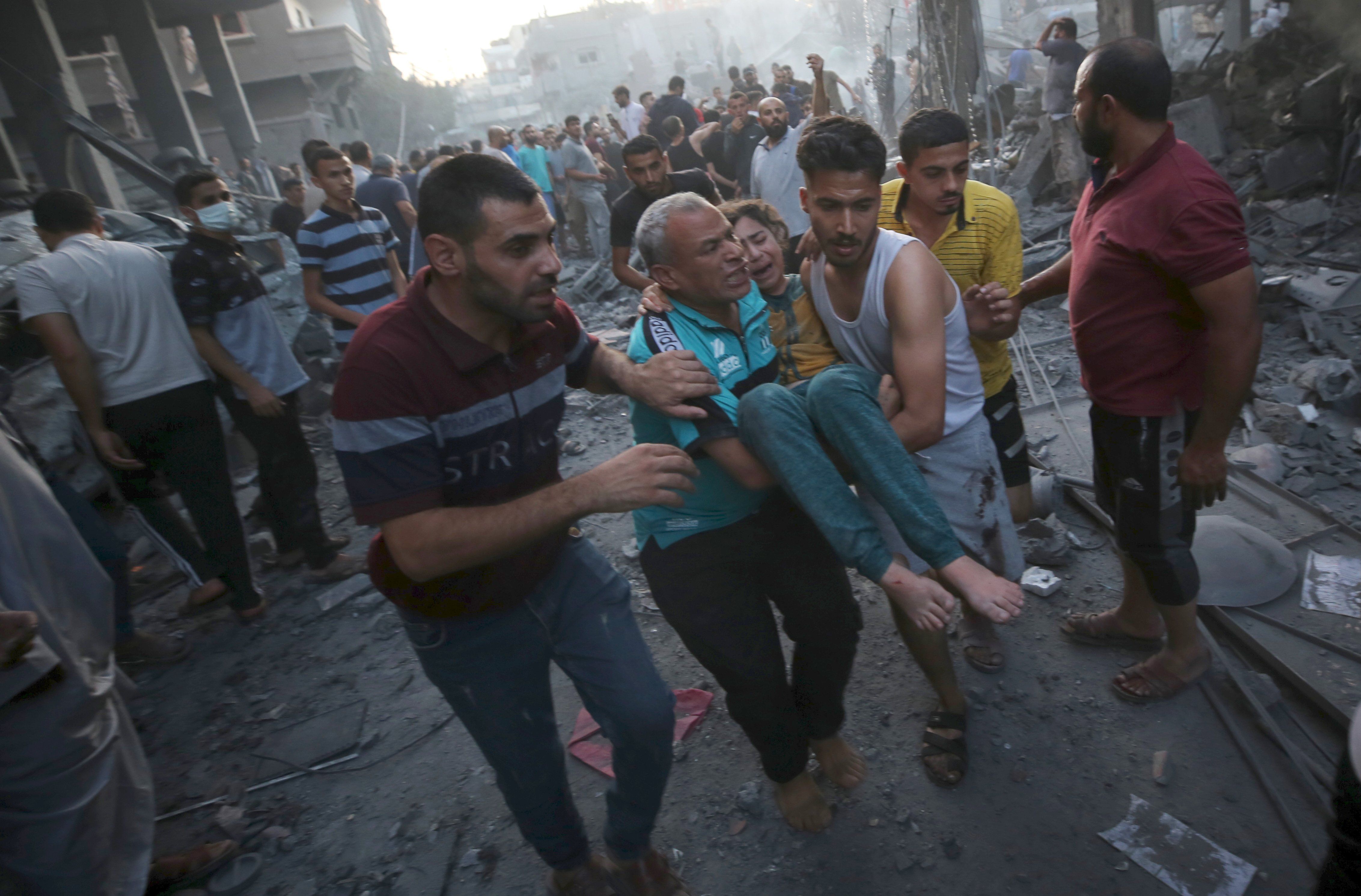 Palestinians evacuate an injured girl following an Israeli airstrike in central Gaza, on Oct. 18, 2023, amid the ongoing battles between Israel and Hamas.