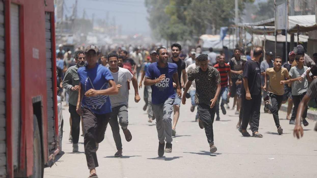 Palestinians flee the area after an Israeli attack on July 13, 2024 in Khan Younis, Gaza Strip.