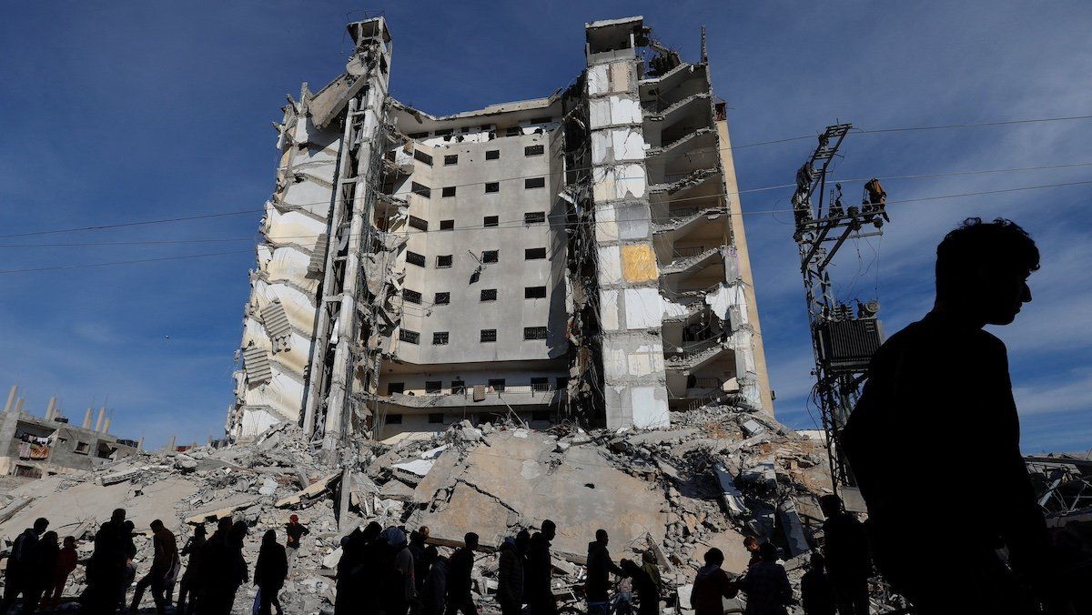 Palestinians gather near a building damaged in an Israeli air strike, amid the ongoing conflict between Israel and the Palestinian Islamist group Hamas, in Rafah, in the southern Gaza Strip March 9, 2024.