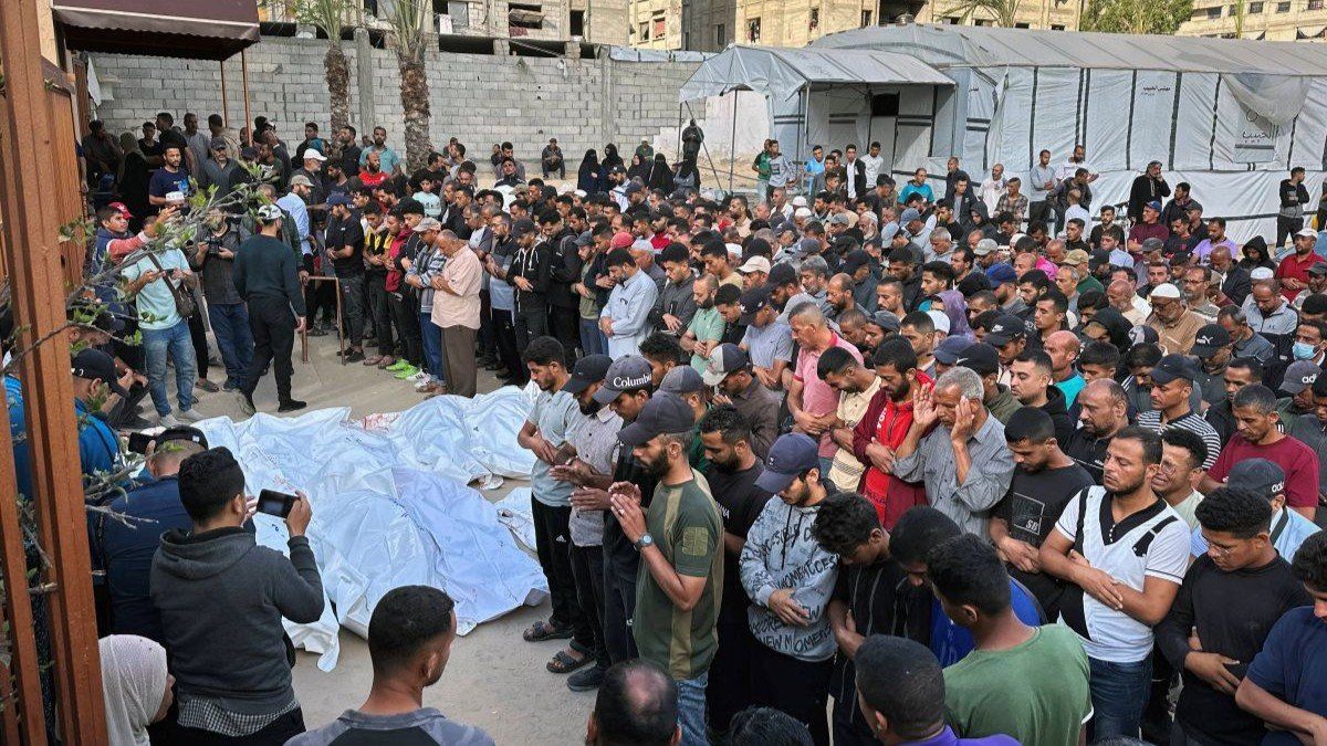​Palestinians mourn by the bodies of relatives who were killed by Israeli fire at the Nasser hospital in southern Gaza, on June 3, 2025.