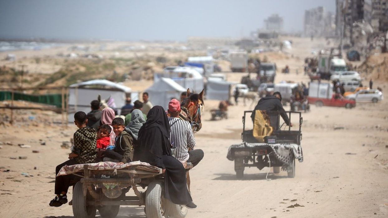 Palestinians travel in vehicles between the northern and southern Gaza Strip along the Rashid Road on April 2, 2025. 
