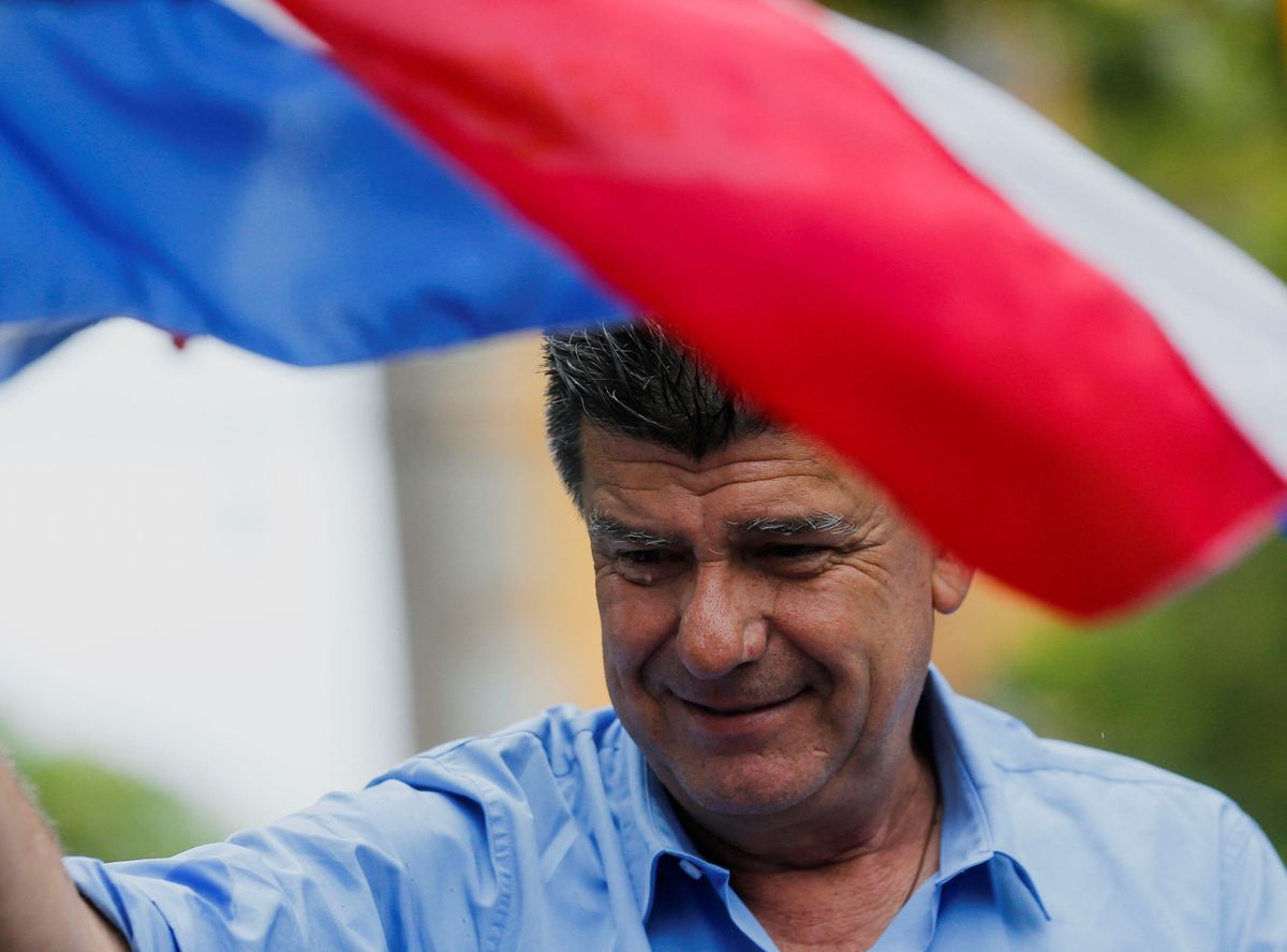 Paraguayan presidential candidate Efrain Alegre waves a flag during a campaign rally in Fernando de la Mora.