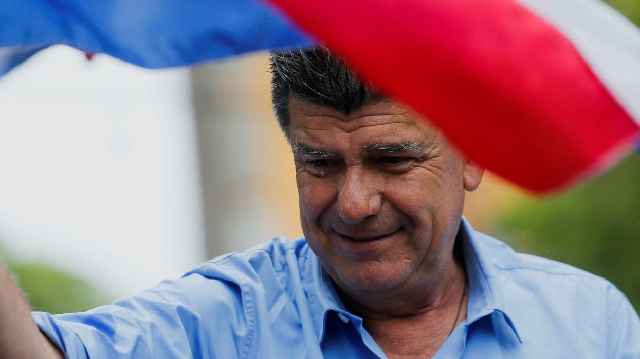 Paraguayan presidential candidate Efrain Alegre waves a flag during a campaign rally in Fernando de la Mora.