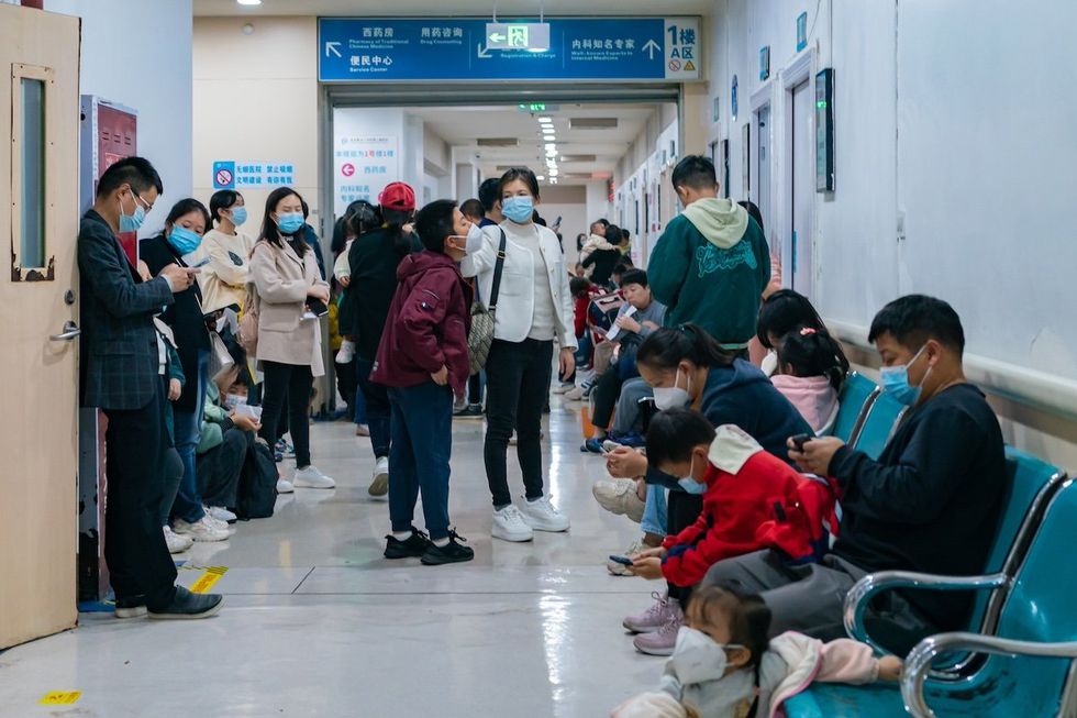 Parents with children who are suffering from respiratory diseases are lining up at a children's hospital in Chongqing, China, on November 23, 2023. (Photo by Costfoto/NurPhoto)