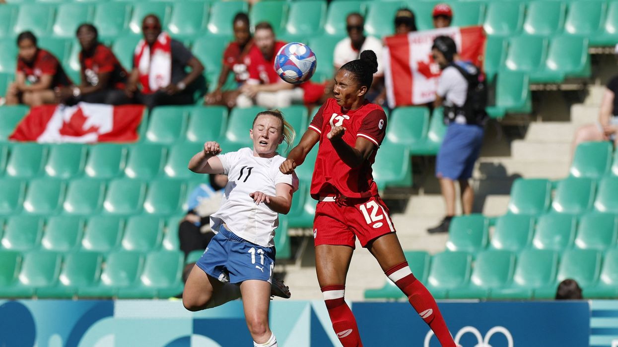 Paris 2024 Olympics - Football - Women's Group A - Canada vs New Zealand - Geoffroy-Guichard Stadium, Saint-Etienne, France - July 25, 2024. Katie Kitching of New Zealand in action with Jade Rose of Canada.
