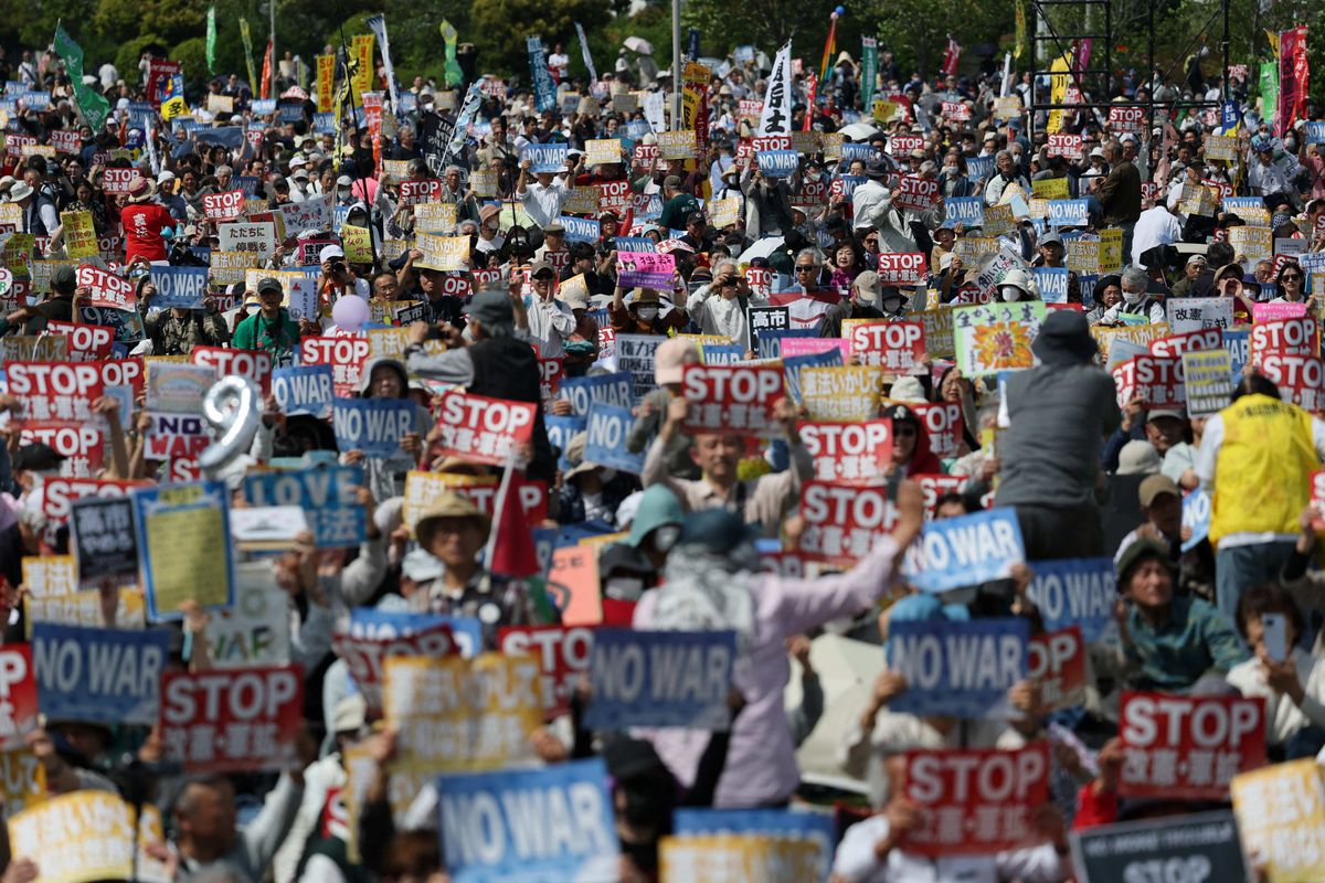 Participants and protesters hold posters opposing Japan’s Prime Minister Sanae Takaichi's administration and her policies on constitutional revision and military expansion during a Constitution Memorial Day rally in Tokyo, Japan, May 3, 2026. 