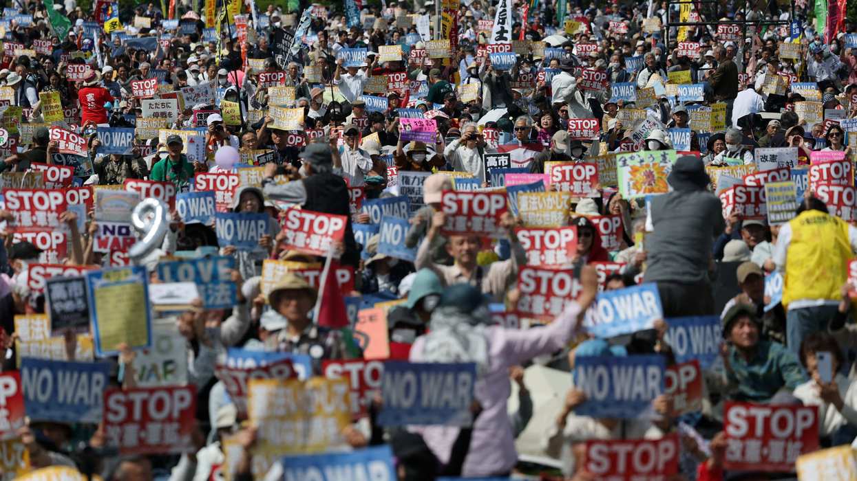 Participants and protesters hold posters opposing Japan’s Prime Minister Sanae Takaichi's administration and her policies on constitutional revision and military expansion during a Constitution Memorial Day rally in Tokyo, Japan, May 3, 2026.