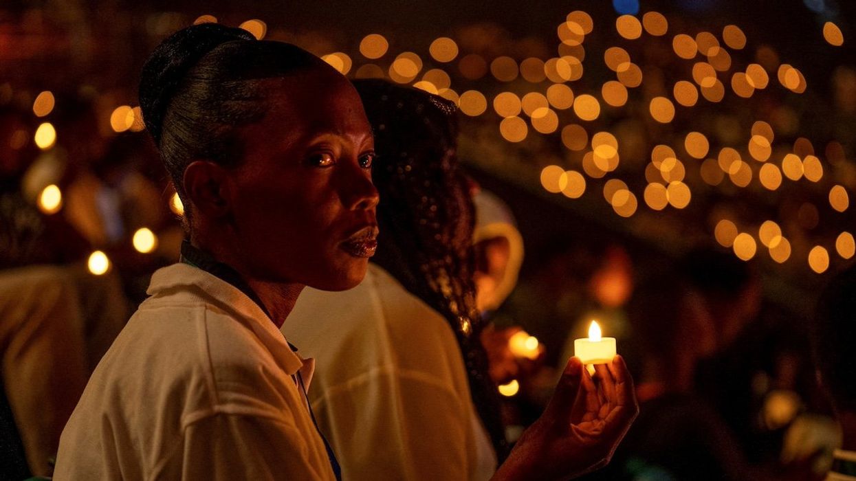 Participants hold a candle light night vigil during a commemoration event, known as "Kwibuka" (Remembering), as Rwanda marks the 30th anniversary of the 1994 Genocide, at the BK arena in Kigali, Rwanda April 7, 2024.