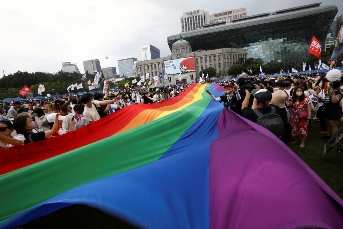 Participants wave rainbow flags during the Korea Queer Culture Festival 2022 in central Seoul, South Korea, July 16, 2022.