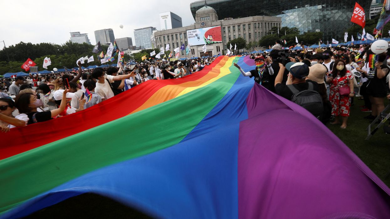 Participants wave rainbow flags during the Korea Queer Culture Festival 2022 in central Seoul, South Korea, July 16, 2022.