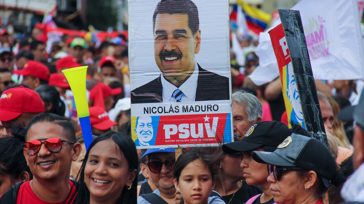 People are carrying a banner with political phrases during a rally in support of Nicolas Maduro's campaign in San Cristobal, Venezuela, on July 10, 2024.