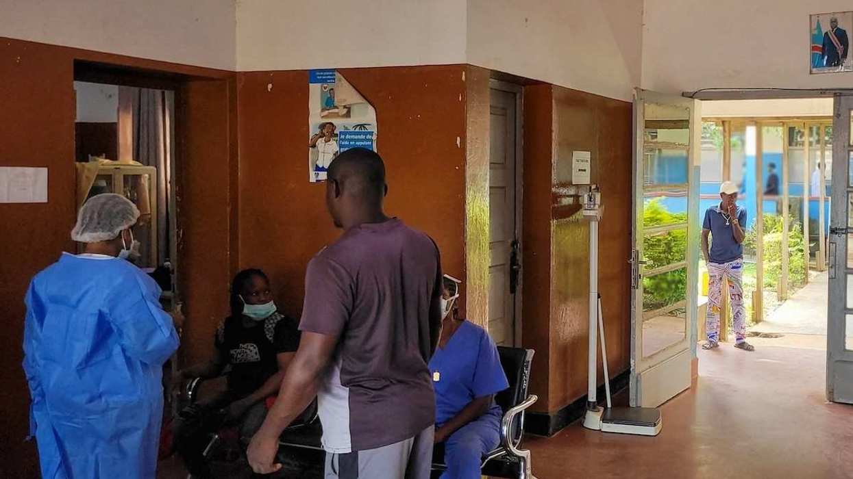 People at a hospital wearing masks amid an Ebola outbreak