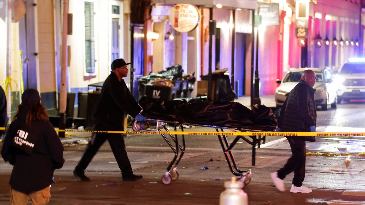 People carry a dead body in a body bag on a stretcher near the site where people were killed by a man driving a truck in an attack during New Year's celebrations, in New Orleans, Louisiana, U.S., January 2, 2025.