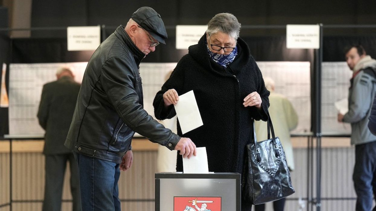 People cast their votes during general election in Utena, Lithuania October 13, 2024.