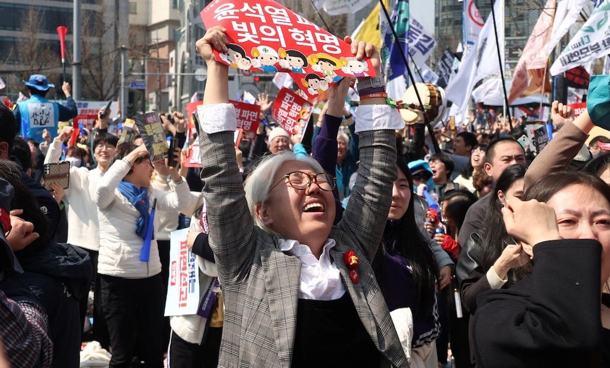 ​People celebrate after President Yoon Suk-yeol's impeachment was accepted, near the Constitutional Court in Seoul, South Korea, on April 4, 2025. 