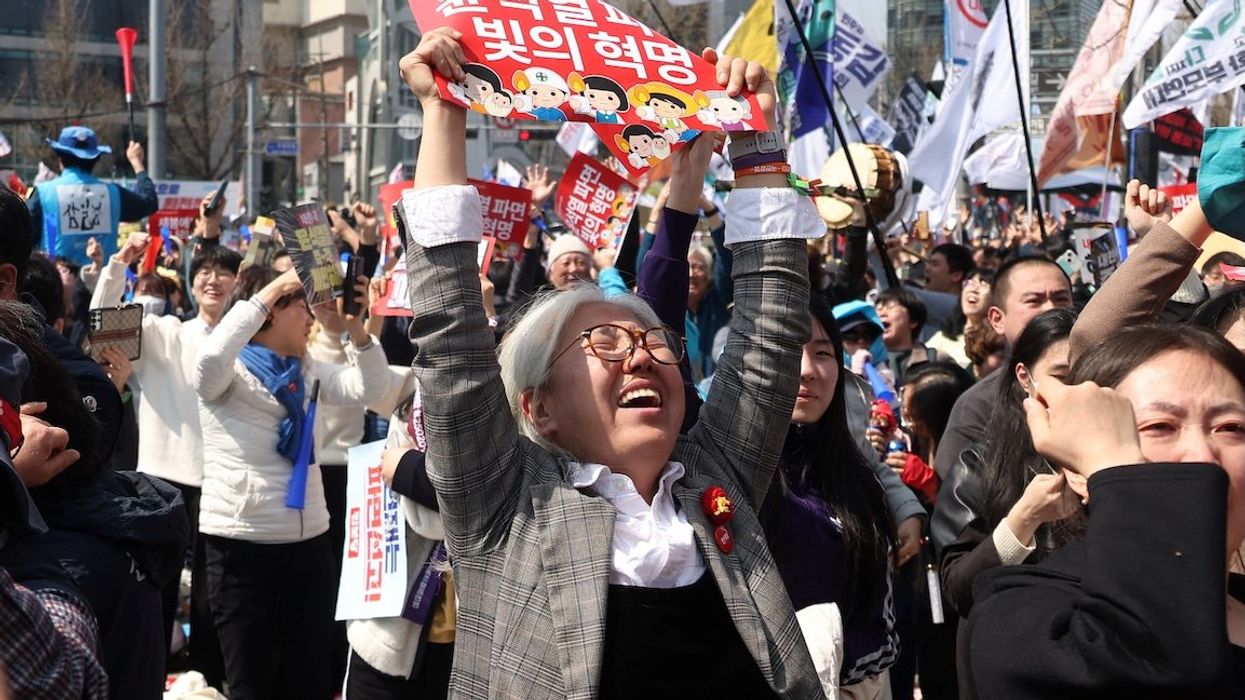 People celebrate after President Yoon Suk-yeol's impeachment was accepted, near the Constitutional Court in Seoul, South Korea, on April 4, 2025.