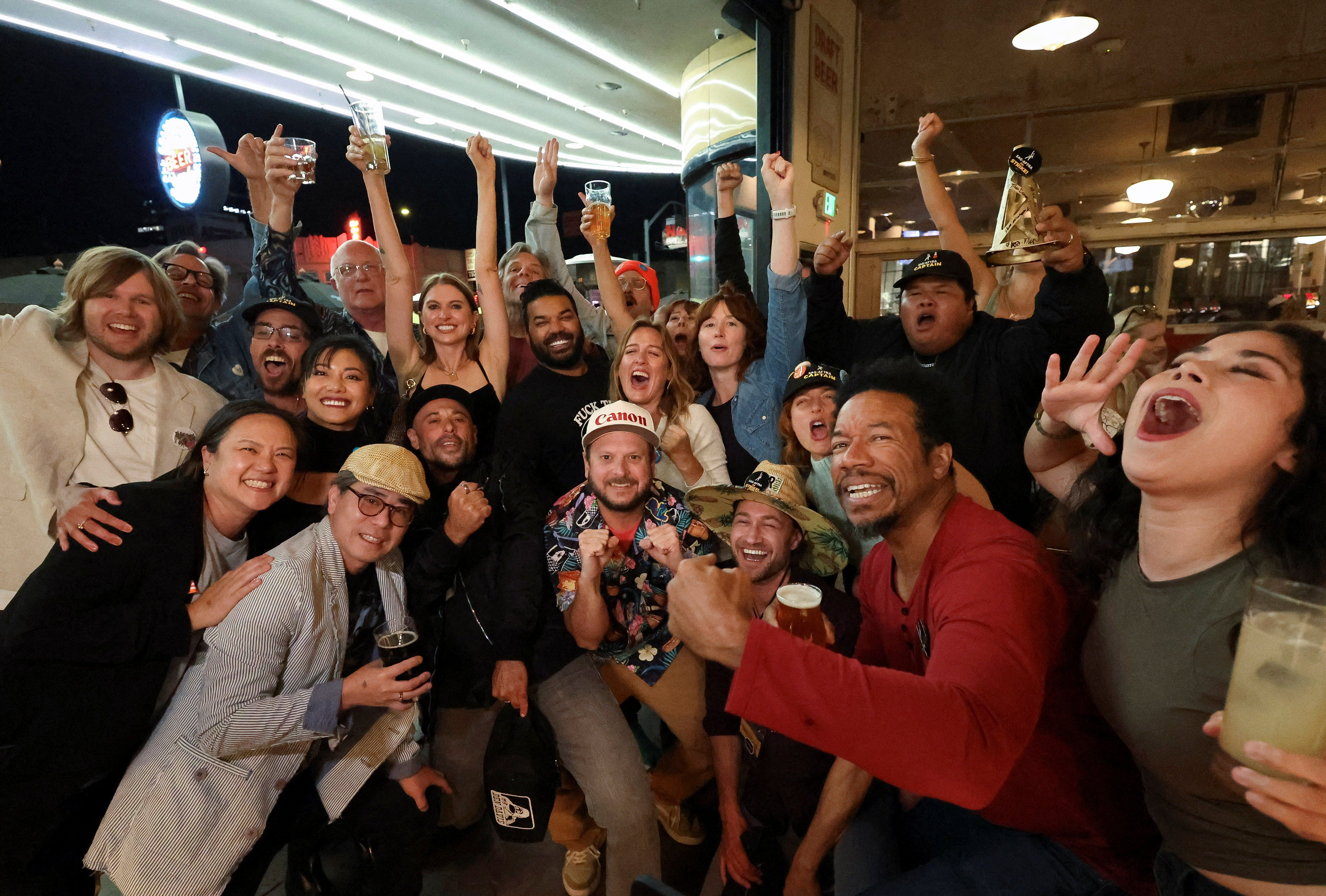 People celebrate after the SAG-AFTRA TV/Theatrical Committee approved a tentative agreement with the Alliance of Motion Picture and Television Producers (AMPTP) to bring an end to the 118-day actors' strike, at a brewery in Los Angeles, California, on Nov. 8, 2023.