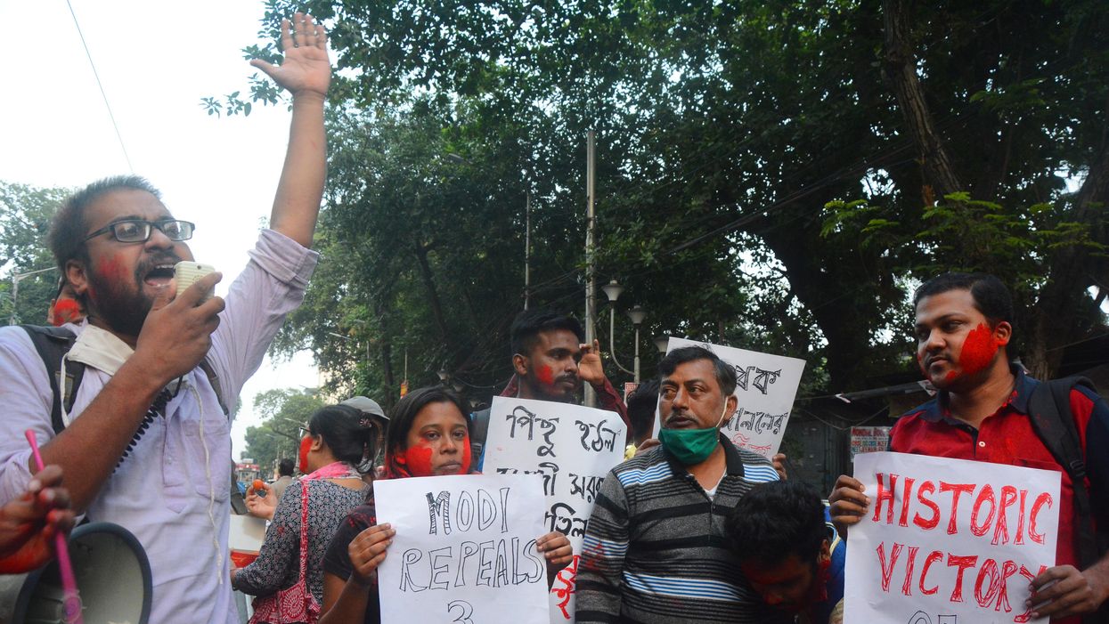 People celebrate in Kolkata, India on Nov. 19, 2021 after Indian PM Narendra Modi announced the repeal of three controversial farm laws after a year of protests. Friday's surprise announcement marks a major U-turn as the government had not taken any initiative to talk to farmers in recent months.