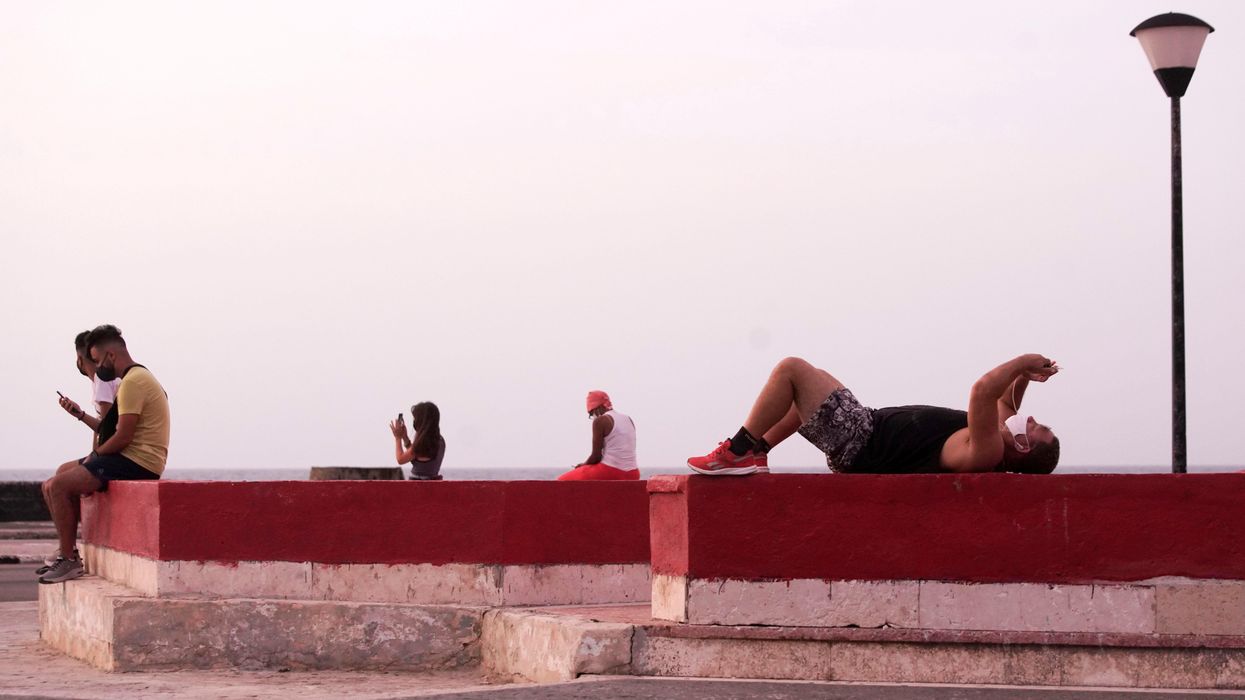 People connect to the internet at a public hotspot in Havana, Cuba, August 18, 2021
