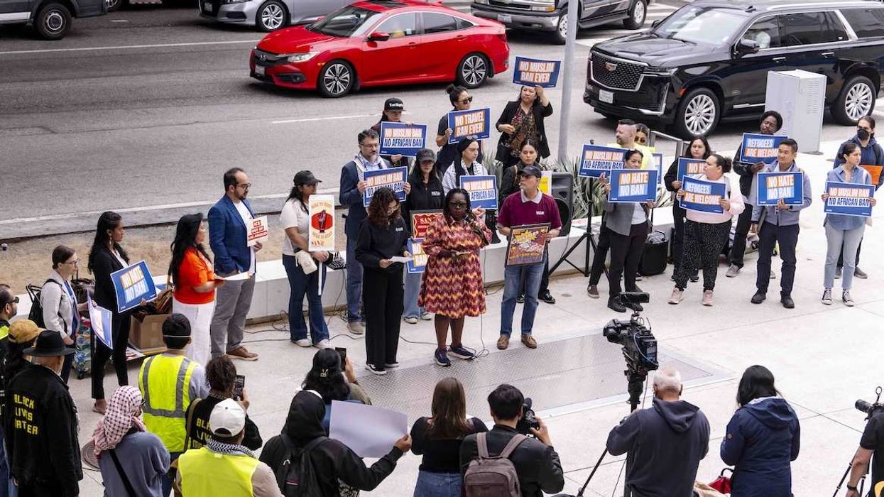 People gather outside the Tom Bradley International Terminal at Los Angeles International Airport to decry President Trump's travel ban on 19 countries which went into effect this morning.