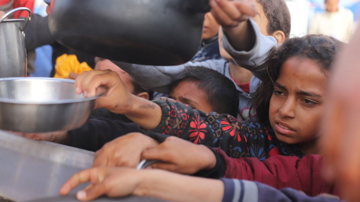 People gather to get food relief in the southern Gaza Strip city of Rafah, on March 17, 2024.