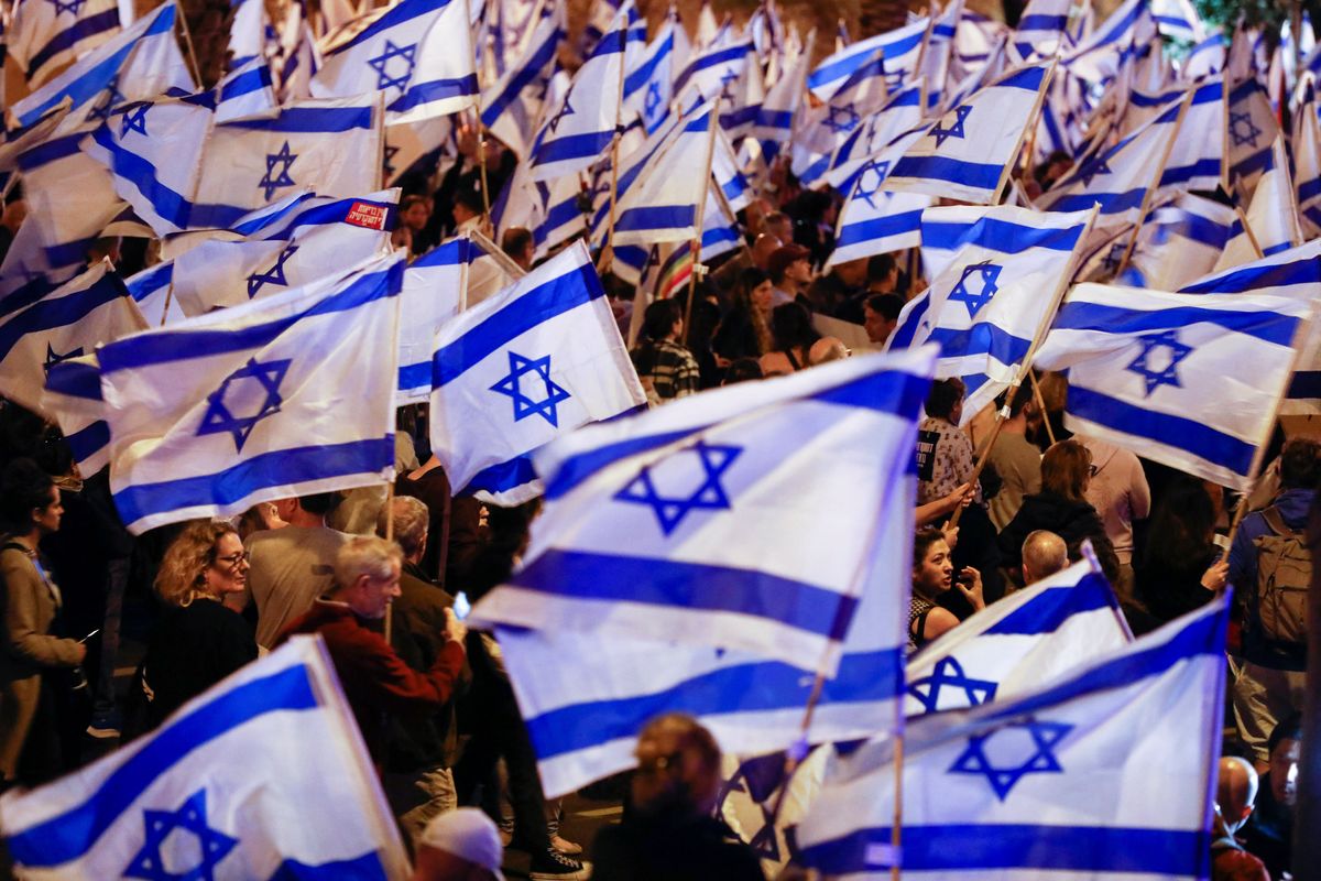 People hold Israeli flags during a demonstration in Tel Avis against PM Benjamin Netanyahu's plans for judicial overhaul.