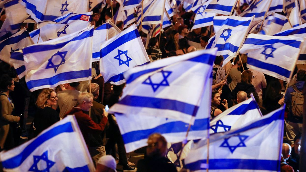 People hold Israeli flags during a demonstration in Tel Avis against PM Benjamin Netanyahu's plans for judicial overhaul.