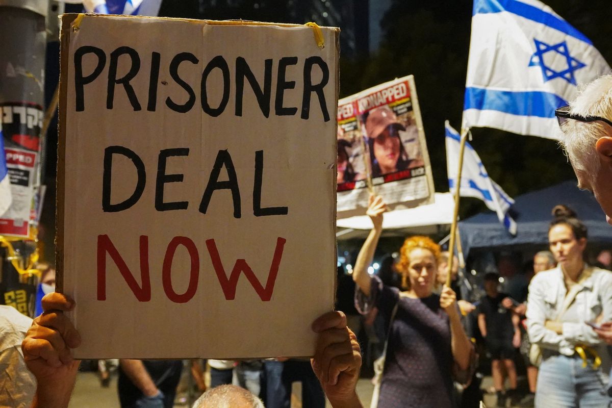 ​People hold placards during a demonstration to show support and solidarity with the families of hostages who are being held in Gaza, in Tel Aviv, Israel, Oct. 21, 2023. 