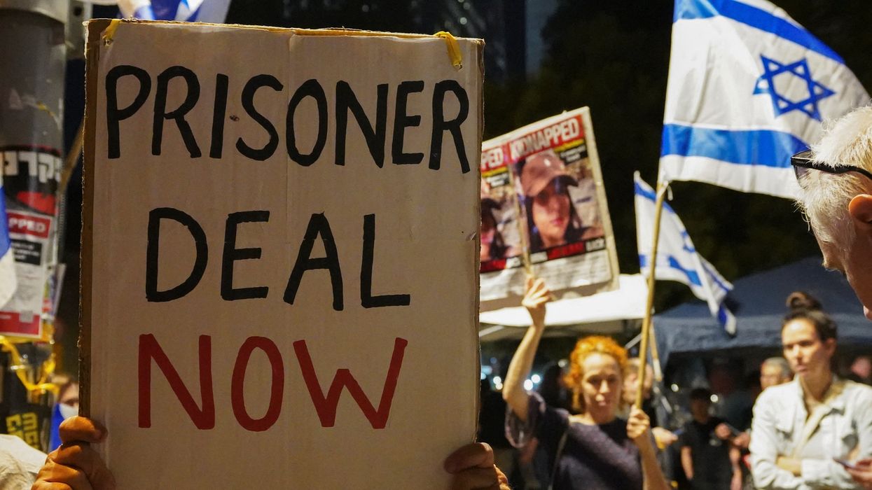People hold placards during a demonstration to show support and solidarity with the families of hostages who are being held in Gaza, in Tel Aviv, Israel, Oct. 21, 2023.