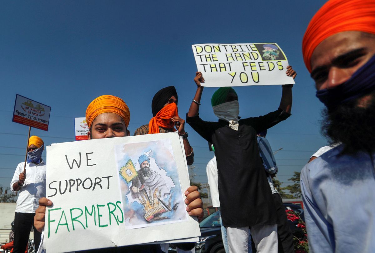 People hold placards during a nationwide strike to protest against newly passed farm bills, in Mumbai, India