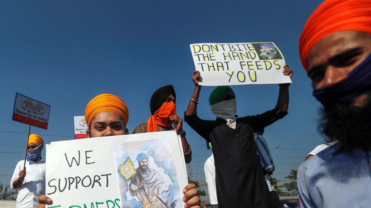 People hold placards during a nationwide strike to protest against newly passed farm bills, in Mumbai, India