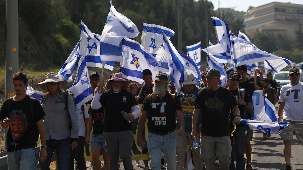 People march towards Jerusalem during a rally against the government and Israeli Prime Minister Benjamin Netanyahu to demand the release of all hostages from Gaza, on March 18, 2025.