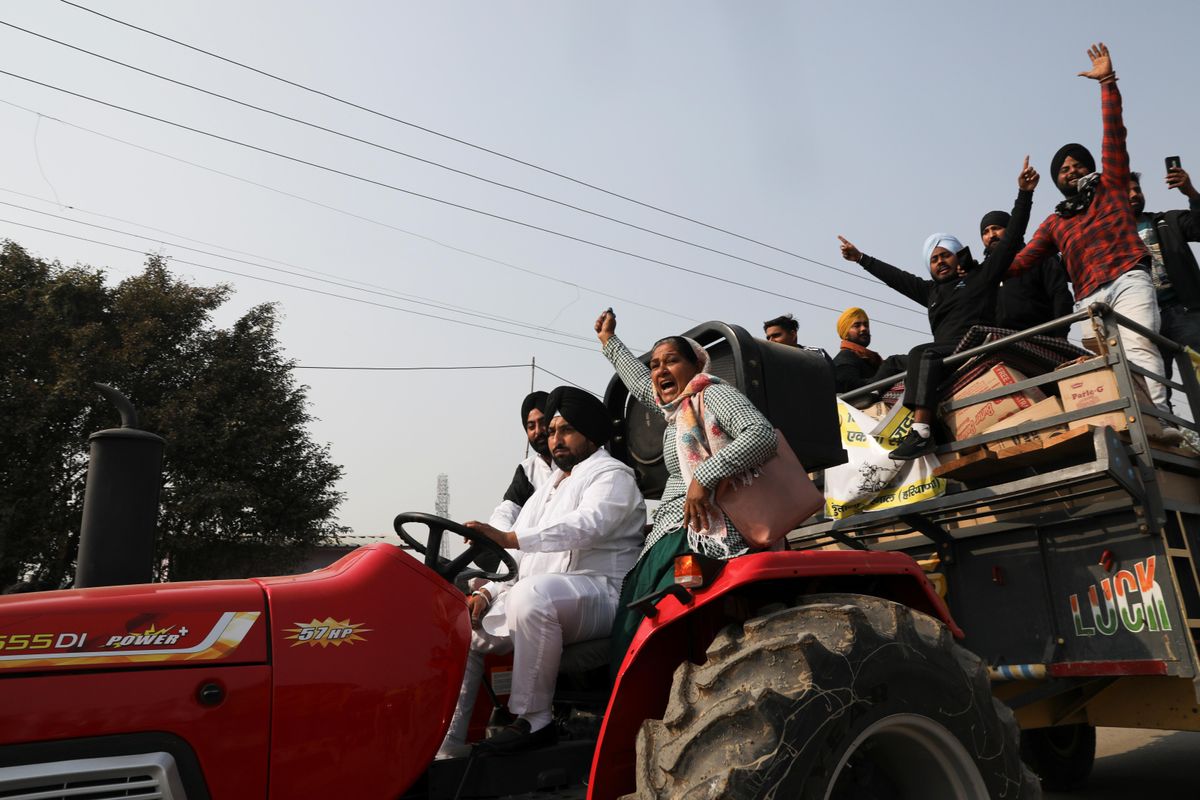 People on a tractor shout slogans at a site of a protest against the newly passed farm bills at Singhu border near Delhi, India, December 1, 2020.