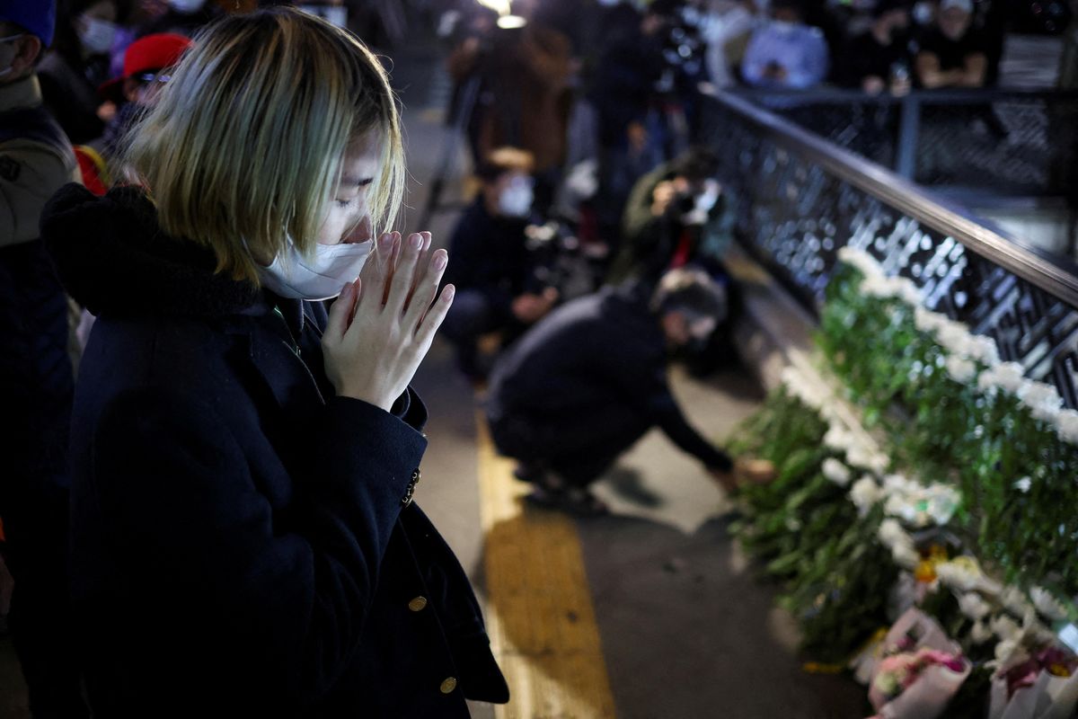 People pay tribute near the scene of the stampede during Halloween festivities in Seoul.